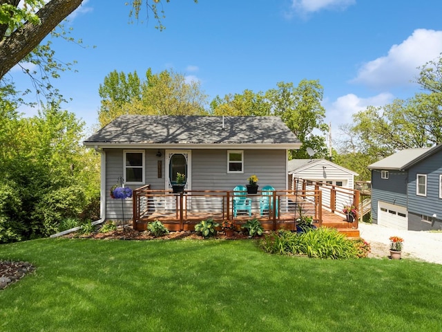 8117 Hickory St, Dexter, IA 50070 - view of front facade featuring a wooden deck, a front yard, and a shingled roof