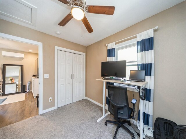 8117 Hickory St, Dexter, IA 50070 - office area featuring ceiling fan, baseboards, carpet, and a wall unit AC