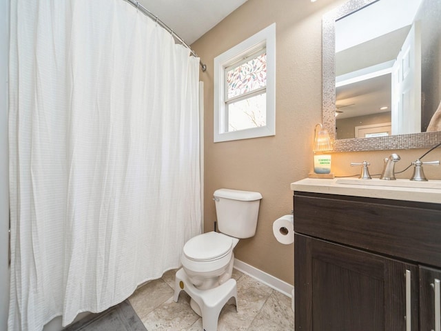 8117 Hickory St, Dexter, IA 50070 - full bathroom featuring toilet, vanity, and baseboards