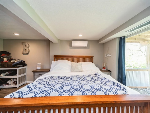 8117 Hickory St, Dexter, IA 50070 - bedroom featuring a wall mounted air conditioner, recessed lighting, wood finished floors, and a textured ceiling