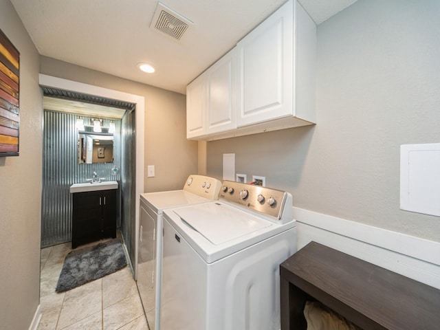8117 Hickory St, Dexter, IA 50070 - laundry area with separate washer and dryer, cabinet space, and light tile patterned flooring
