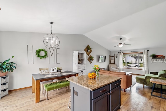 2009 NW Boulder Ridge Ln, Ankeny, IA 50023 - kitchen with vaulted ceiling, light wood-type flooring, a chandelier, a ceiling fan, and a kitchen island