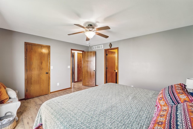 2009 NW Boulder Ridge Ln, Ankeny, IA 50023 - bedroom with light wood-type flooring, ceiling fan, and baseboards