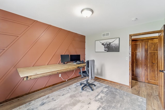 2009 NW Boulder Ridge Ln, Ankeny, IA 50023 - office area featuring a decorative wall, wood finished floors, and baseboards