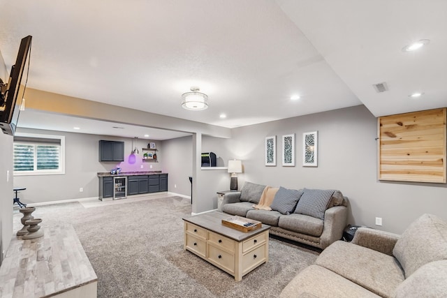 2009 NW Boulder Ridge Ln, Ankeny, IA 50023 - living area with wet bar, recessed lighting, light colored carpet, and baseboards