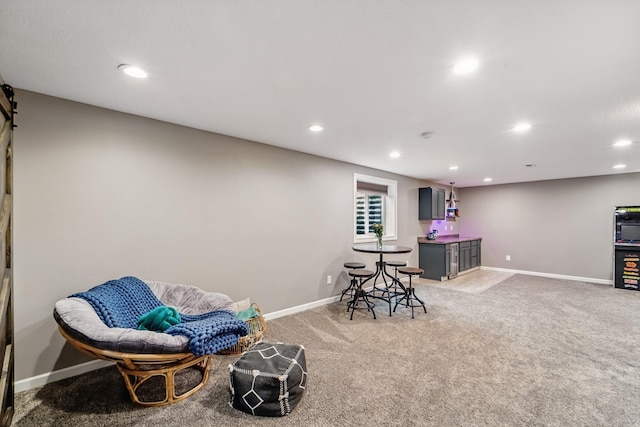 2009 NW Boulder Ridge Ln, Ankeny, IA 50023 - sitting room featuring recessed lighting, light carpet, baseboards, and bar area