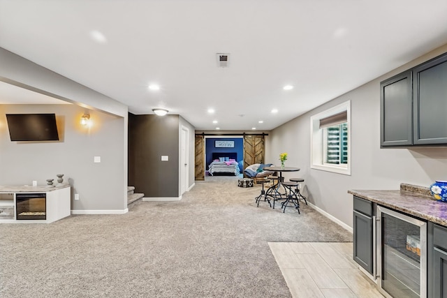 2009 NW Boulder Ridge Ln, Ankeny, IA 50023 - recreation room with wine cooler, light carpet, baseboards, and recessed lighting