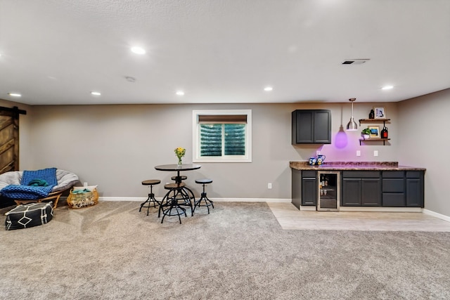 2009 NW Boulder Ridge Ln, Ankeny, IA 50023 - recreation room featuring a barn door, bar with sink, light carpet, baseboards, and recessed lighting