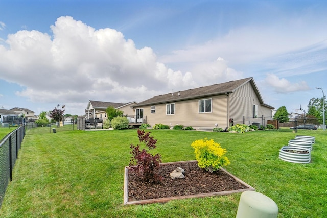 2009 NW Boulder Ridge Ln, Ankeny, IA 50023 - rear view of property with a vegetable garden and a deck