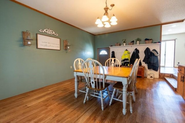 2002 12th St, Eldora, IA 50627 - dining area featuring wood finished floors, a chandelier, and ornamental molding