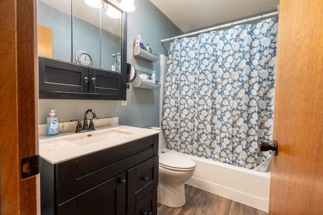 2002 12th St, Eldora, IA 50627 - bathroom featuring wood finished floors, toilet, shower / bath combo with shower curtain, and vanity