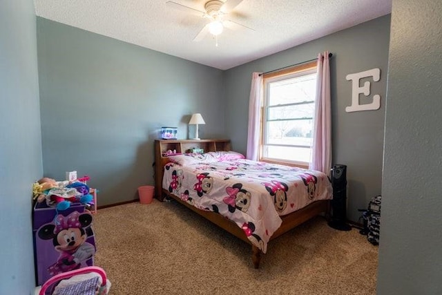2002 12th St, Eldora, IA 50627 - bedroom featuring carpet, a textured ceiling, and ceiling fan
