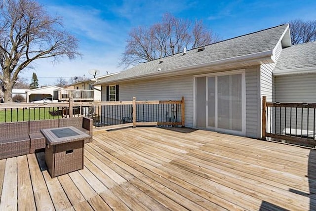 2002 12th St, Eldora, IA 50627 - deck featuring a fire pit