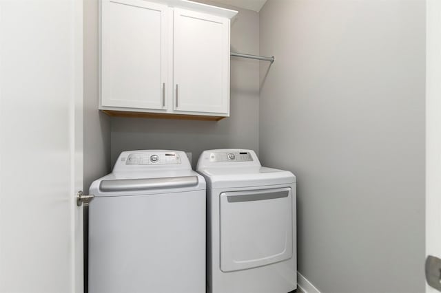 1350 97th St, West Des Moines, IA 50266 - laundry room featuring washer and clothes dryer and cabinet space