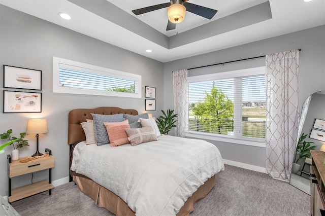 1350 97th St, West Des Moines, IA 50266 - bedroom with baseboards, recessed lighting, ceiling fan, a tray ceiling, and light carpet