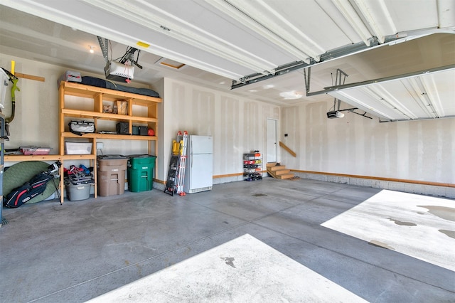 1350 97th St, West Des Moines, IA 50266 - garage with freestanding refrigerator and a garage door opener