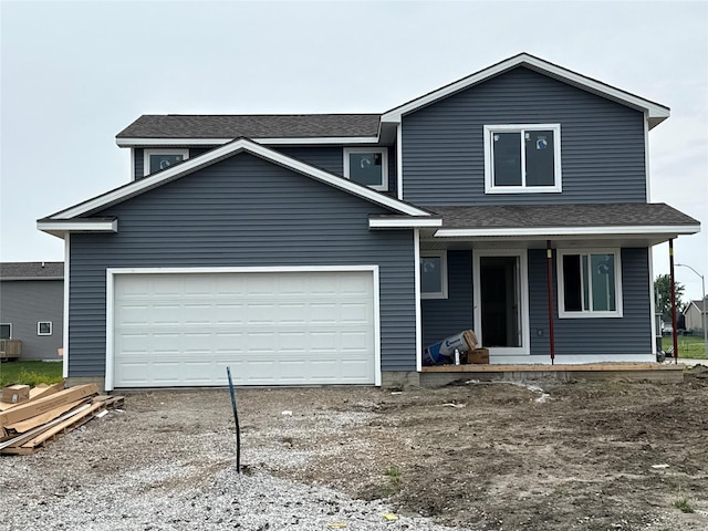 315 NE Chalet St, Elkhart, IA 50073 - view of front of house with a porch, a shingled roof, a garage, and driveway