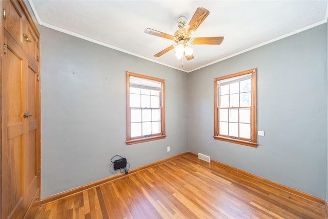 2615 34th St, Des Moines, IA 50310 - empty room featuring light wood-style flooring, baseboards, a ceiling fan, and crown molding