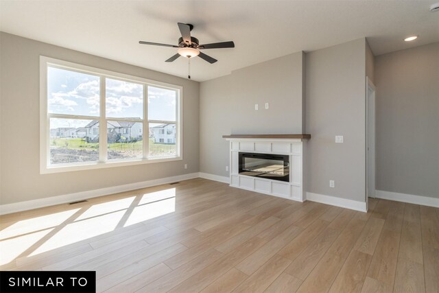 4120 NE 5th St, Ankeny, IA 50021 - unfurnished living room with a glass covered fireplace, baseboards, light wood-style flooring, and recessed lighting