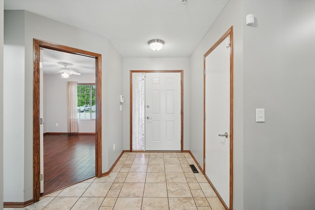 6082 Sheffield Cir, Johnston, IA 50131 - entrance foyer with baseboards, a ceiling fan, and light tile patterned floors