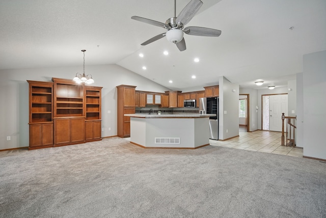 6082 Sheffield Cir, Johnston, IA 50131 - kitchen with appliances with stainless steel finishes, open floor plan, vaulted ceiling, baseboards, and light colored carpet