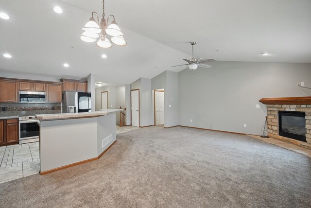 6082 Sheffield Cir, Johnston, IA 50131 - kitchen with appliances with stainless steel finishes, open floor plan, vaulted ceiling, light carpet, and brown cabinetry