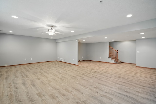 6082 Sheffield Cir, Johnston, IA 50131 - spare room featuring light wood finished floors, recessed lighting, baseboards, and stairs