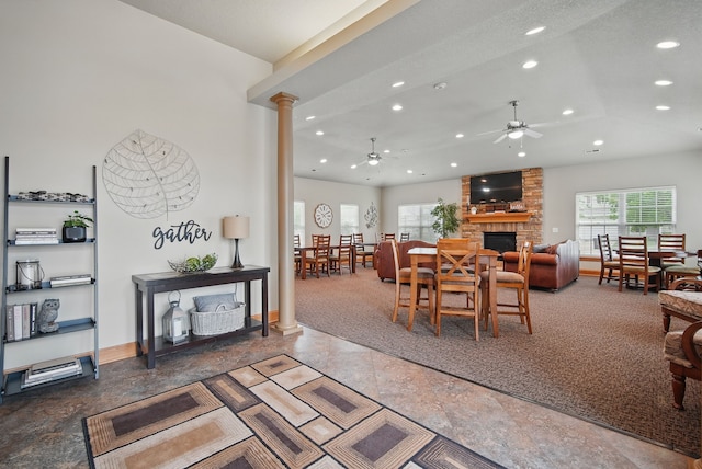 6082 Sheffield Cir, Johnston, IA 50131 - dining space with a ceiling fan, recessed lighting, ornate columns, a stone fireplace, and baseboards