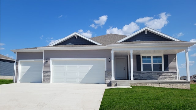 4307 NE 12th St, Ankeny, IA 50021 - view of front of house featuring stone siding, concrete driveway, an attached garage, and a porch
