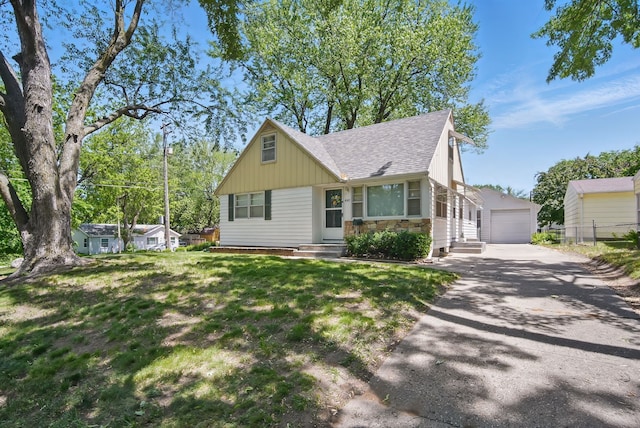 4147 E 7th St, Des Moines, IA 50313 - view of front of home with roof with shingles, stone siding, a garage, board and batten siding, and entry steps
