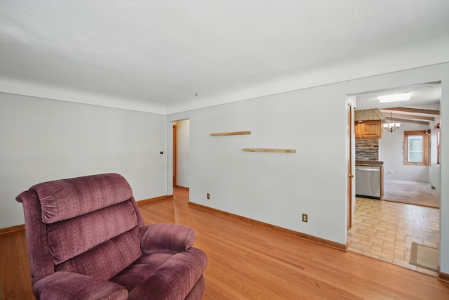 4147 E 7th St, Des Moines, IA 50313 - sitting room with baseboards and light wood-type flooring