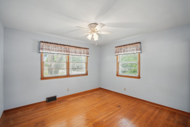 4147 E 7th St, Des Moines, IA 50313 - unfurnished room with a ceiling fan, light wood-style flooring, and baseboards