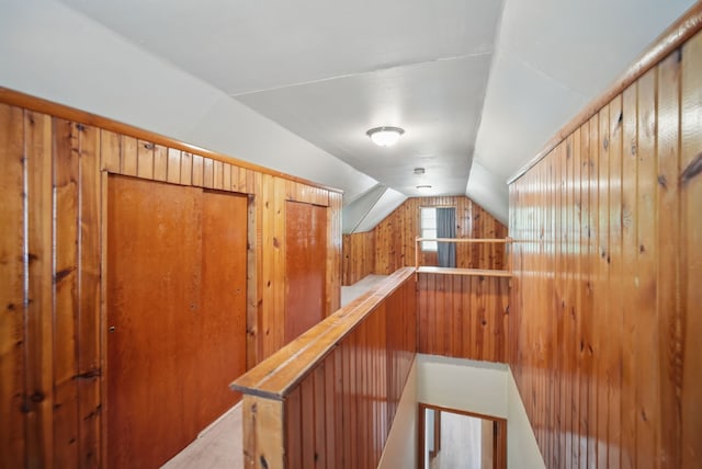 4147 E 7th St, Des Moines, IA 50313 - hallway with an upstairs landing, vaulted ceiling, and wood walls