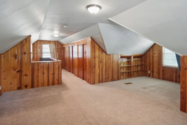 4147 E 7th St, Des Moines, IA 50313 - additional living space featuring wood walls, lofted ceiling, and carpet
