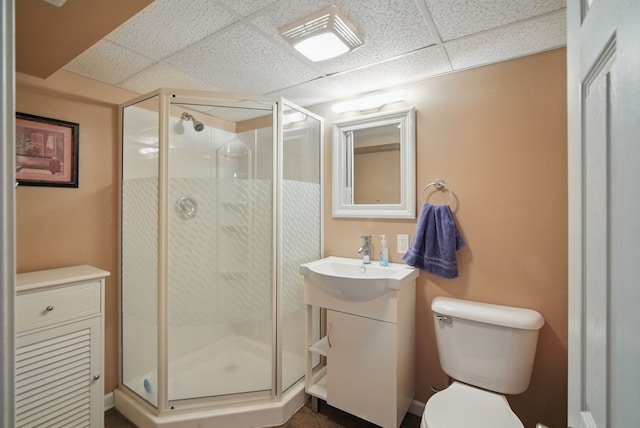 4147 E 7th St, Des Moines, IA 50313 - bathroom with a drop ceiling, vanity, toilet, and a shower stall