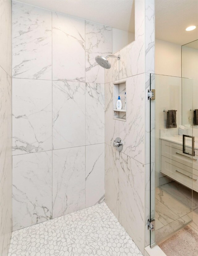 8115 Cobblestone Ct, Urbandale, IA 50322 - full bath featuring a marble finish shower, vanity, and recessed lighting