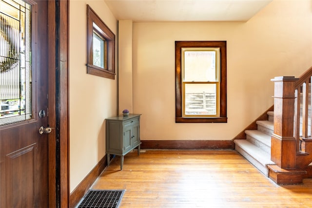 1014 14th St, Boone, IA 50036 - foyer featuring light wood-type flooring, stairway, and baseboards