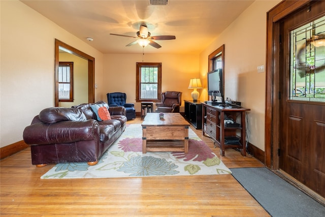 1014 14th St, Boone, IA 50036 - living room with baseboards, a ceiling fan, and wood finished floors