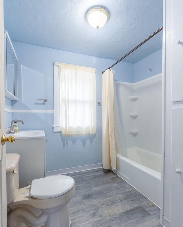 1014 14th St, Boone, IA 50036 - full bath with a textured ceiling, toilet, wood finished floors, shower / bathtub combination with curtain, and vanity