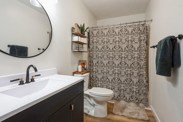 306 E Buchanan St, Baxter, IA 50028 - full bath with wood finished floors, toilet, vanity, and a shower with shower curtain