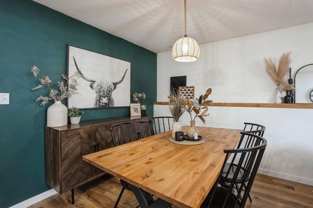 306 E Buchanan St, Baxter, IA 50028 - dining area featuring wood finished floors and baseboards