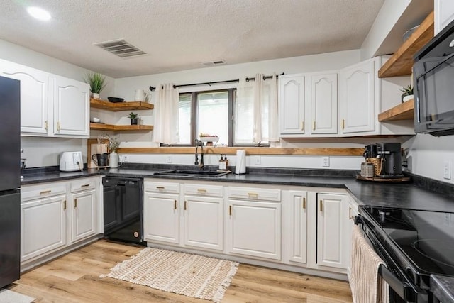 306 E Buchanan St, Baxter, IA 50028 - kitchen with open shelves, black appliances, white cabinets, a textured ceiling, and a sink