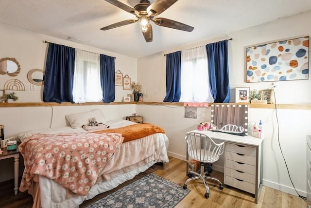 306 E Buchanan St, Baxter, IA 50028 - bedroom with wood finished floors and ceiling fan