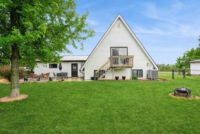 306 E Buchanan St, Baxter, IA 50028 - back of house featuring an outdoor fire pit, a patio area, stairs, and cooling unit
