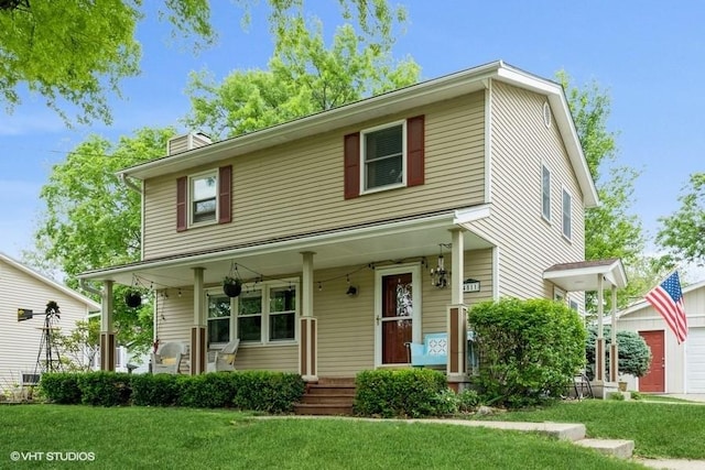 4511 66th St, Urbandale, IA 50322 - view of front of home with covered porch, a front yard, and a chimney