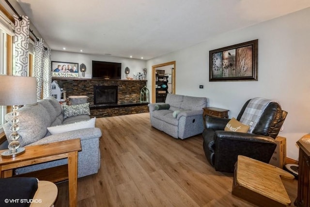4511 66th St, Urbandale, IA 50322 - living room with wood finished floors, a stone fireplace, and recessed lighting