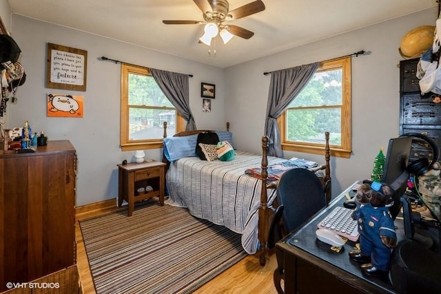 4511 66th St, Urbandale, IA 50322 - bedroom with light wood finished floors, multiple windows, and ceiling fan