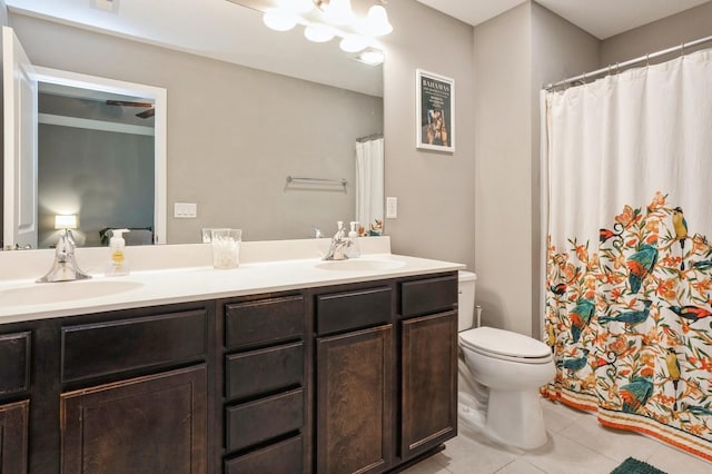 1085 Juniper Dr, Carlisle, IA 50047 - full bathroom with tile patterned floors, double vanity, toilet, and a shower with shower curtain
