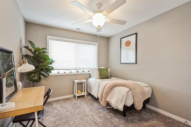 1085 Juniper Dr, Carlisle, IA 50047 - carpeted bedroom with baseboards, a ceiling fan, and a desk