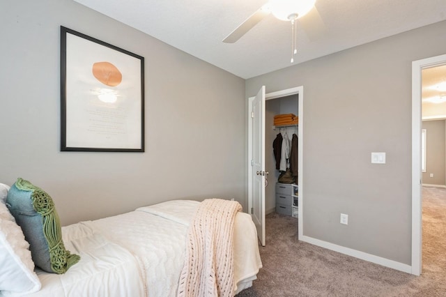 1085 Juniper Dr, Carlisle, IA 50047 - carpeted bedroom featuring baseboards, a closet, a spacious closet, and a ceiling fan